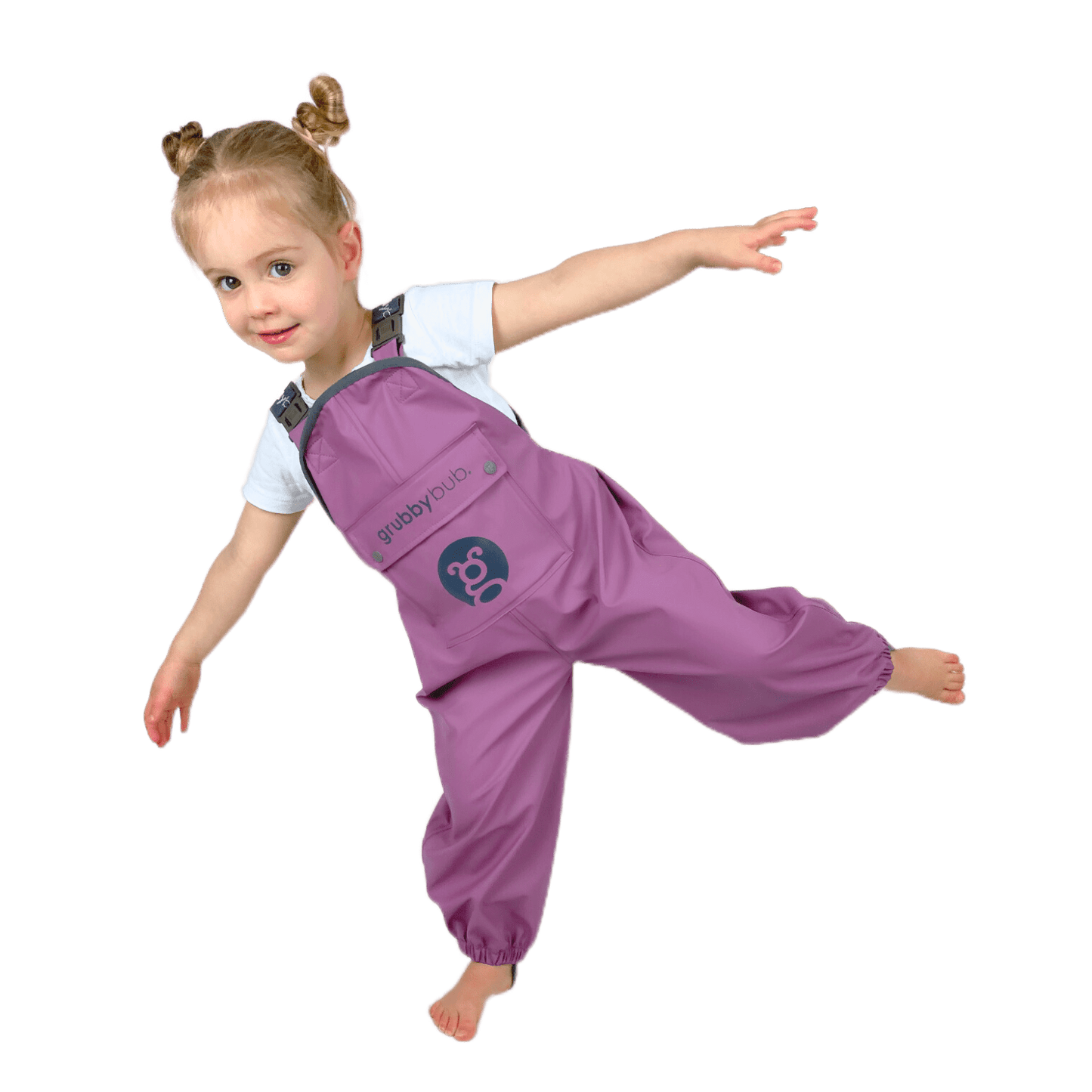 Child wearing waterproof kids overalls jumping and playing, flexible grubberalls designed for outdoor play