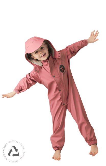 Child in pink waterproof rain suit with hood, kids outdoor play suit for wet weather