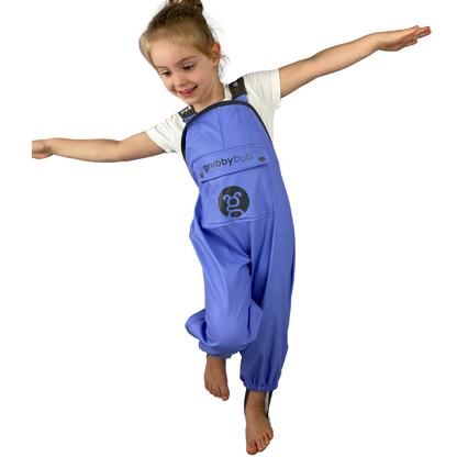 young girl in purple waterproof overalls on a white background