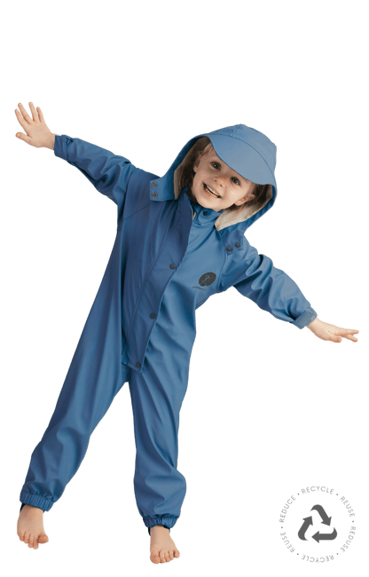 Child in blue waterproof rain suit jumping with arms out, kids all weather outdoor suit
