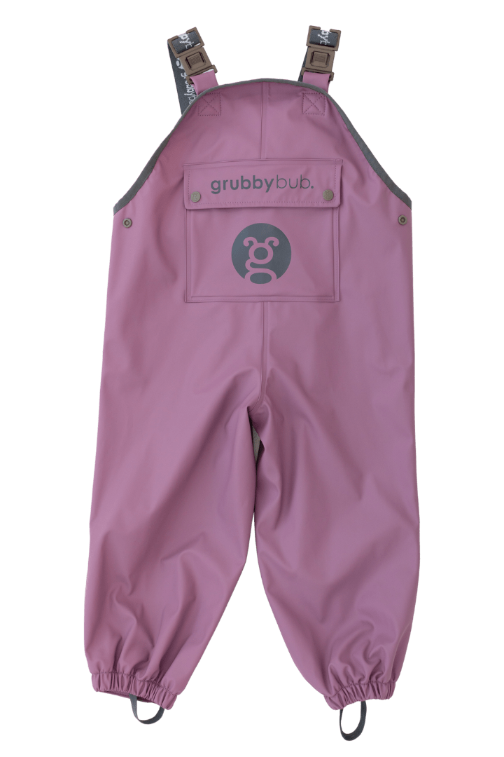 Waterproof overall pants in plum purple. Shown in a flat lay position to highlight features such as the extended growth room and extra adjustability